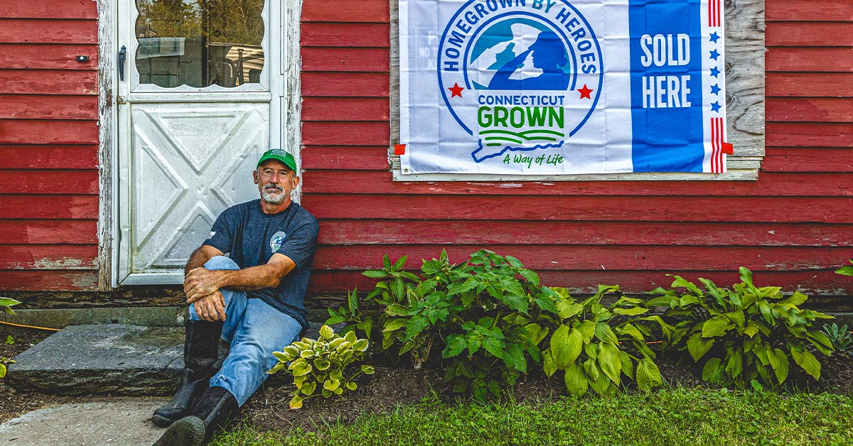 farmer sitting in front of house