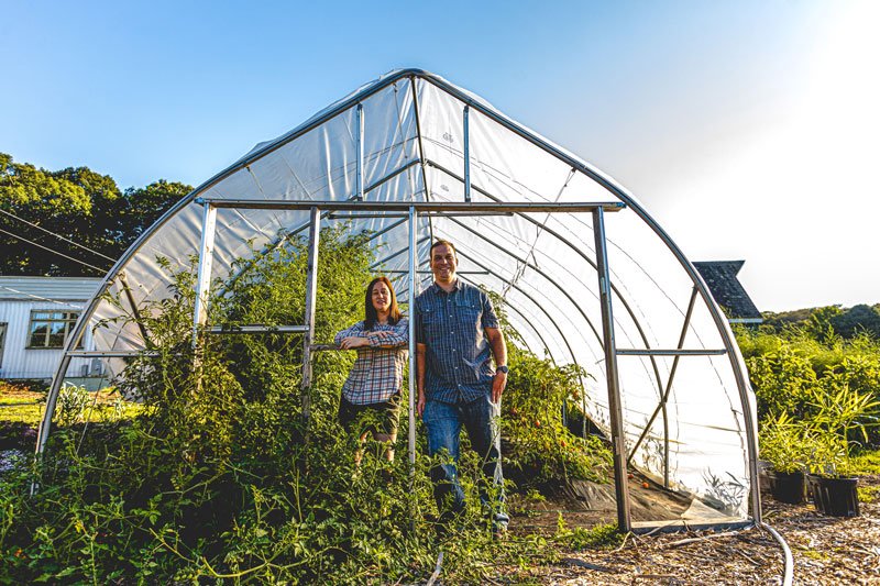 man and woman in greenhouse