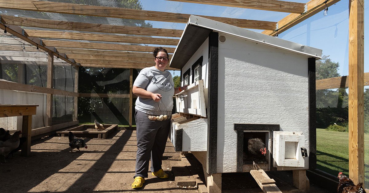 woman by chicken house