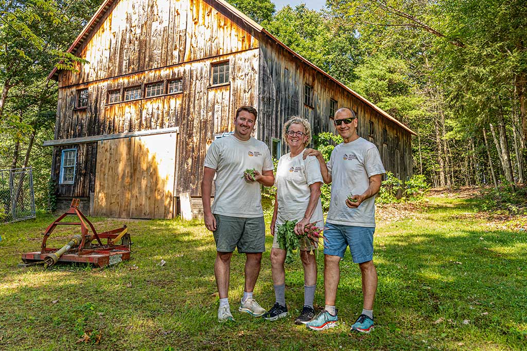 three farmers near barn