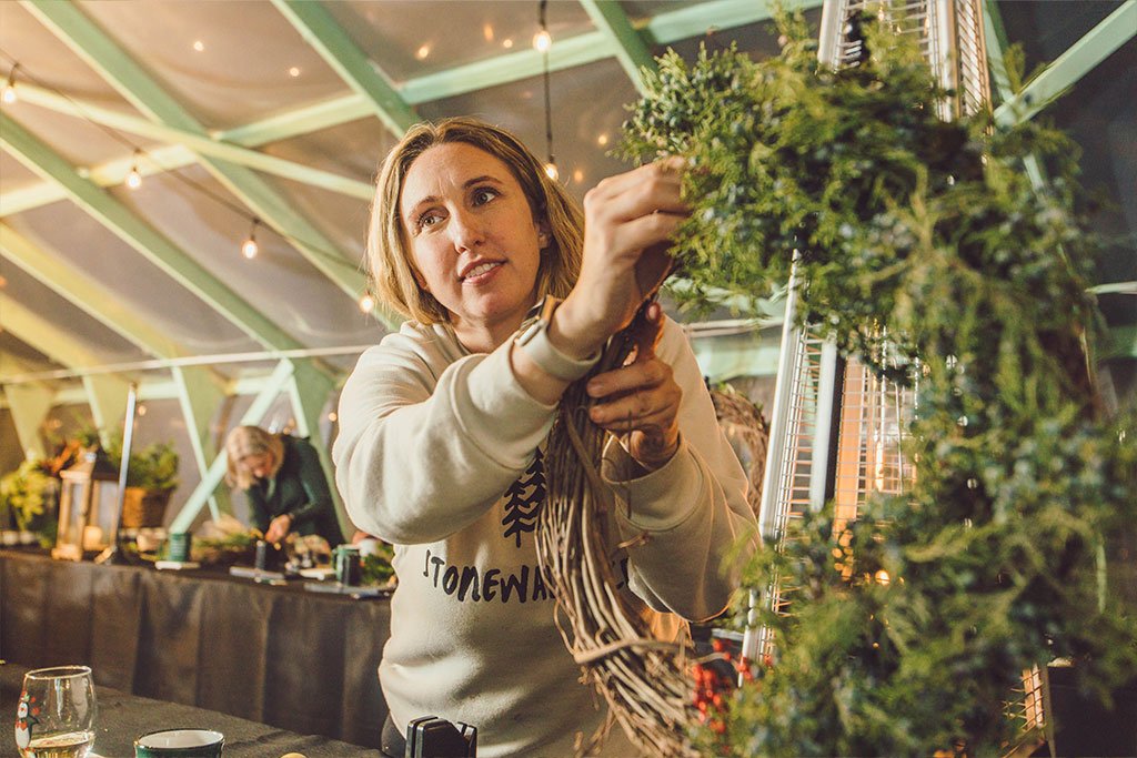 Rachel McKenna holding wreath